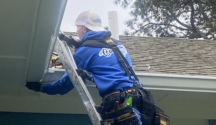 Person installing lifetime gutter Person installing lifetime gutter