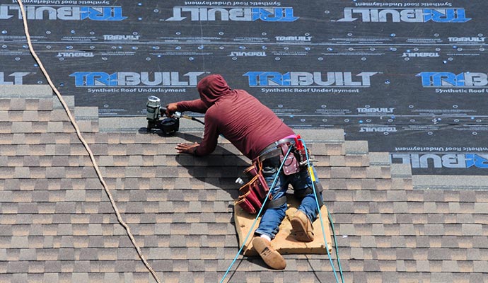 A person is installing roof A person is installing roof