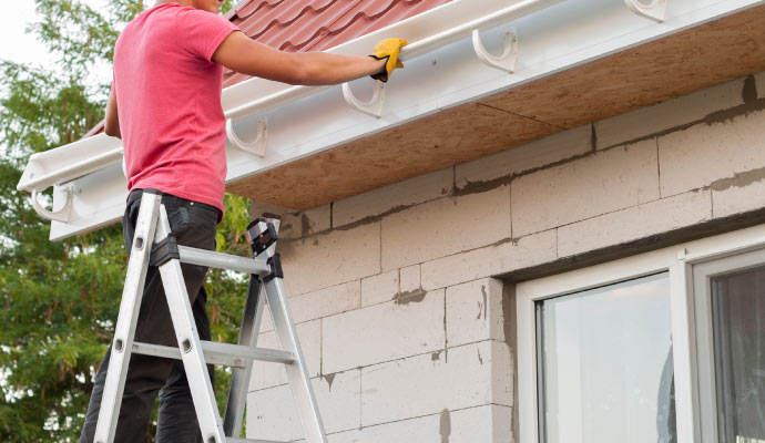 Person installing gutter